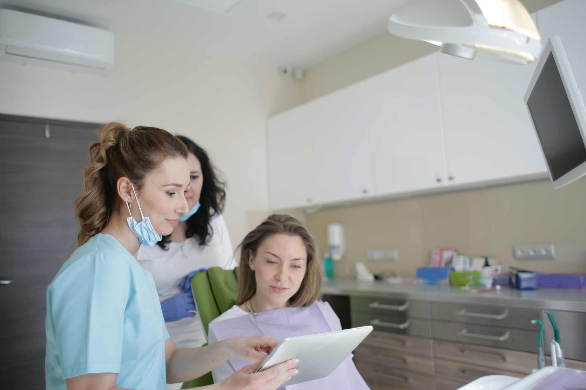 woman-dentist-checking-patient-records